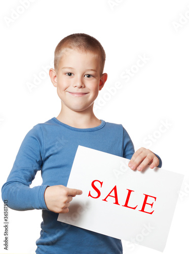 smiling boy holding blank sheet of paper