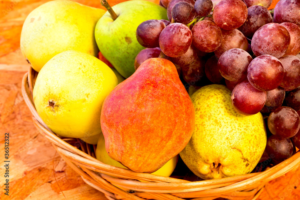 yellow, red and green pears with bunch of red grapes