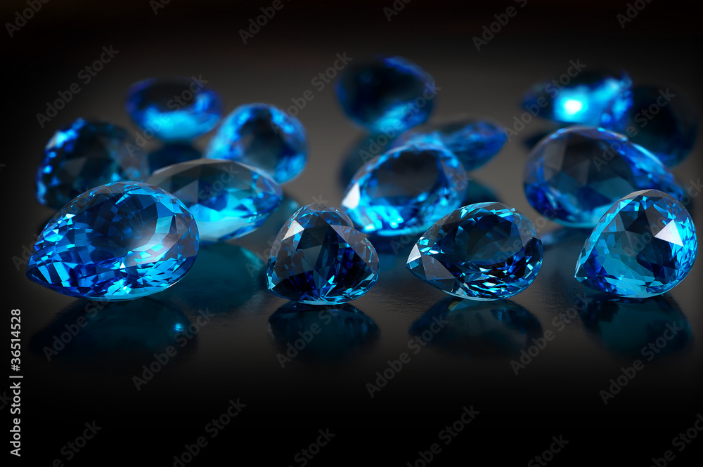 Group of topaz gemstones on dark background.