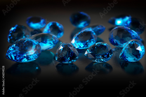 Group of topaz gemstones on dark background.