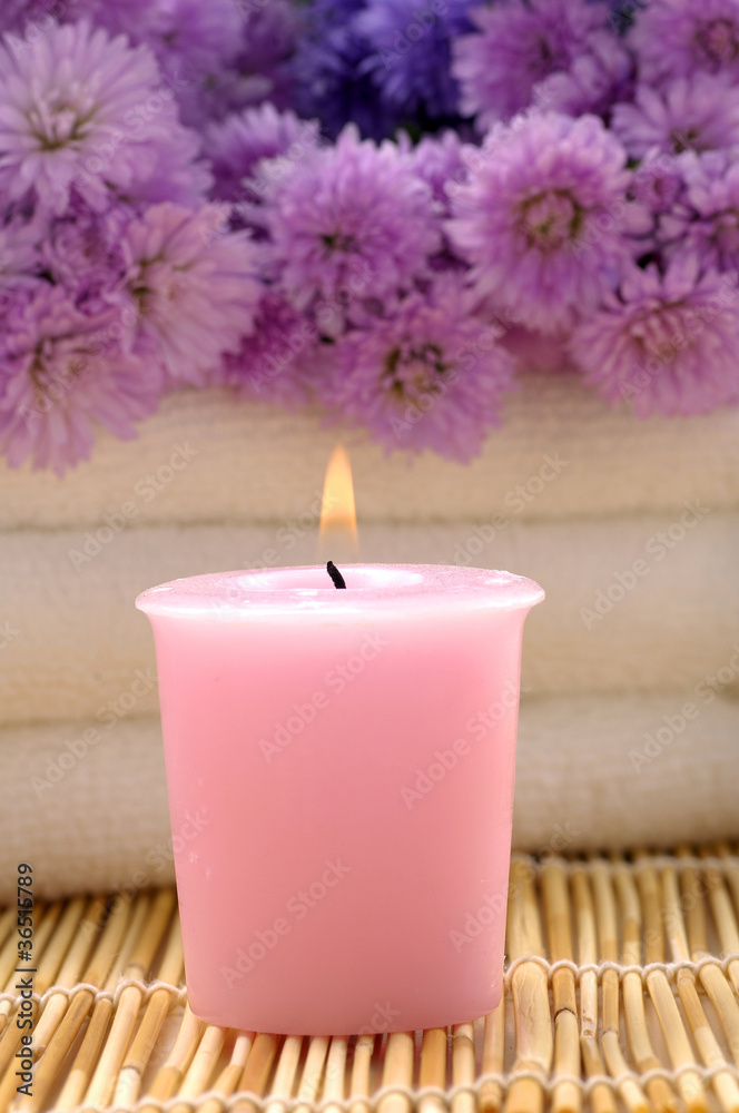Body relax composition with pink flower and candle on mat