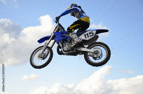 Fototapeta Naklejka Na Ścianę i Meble -  High flight of motocross racer on a motorcycle