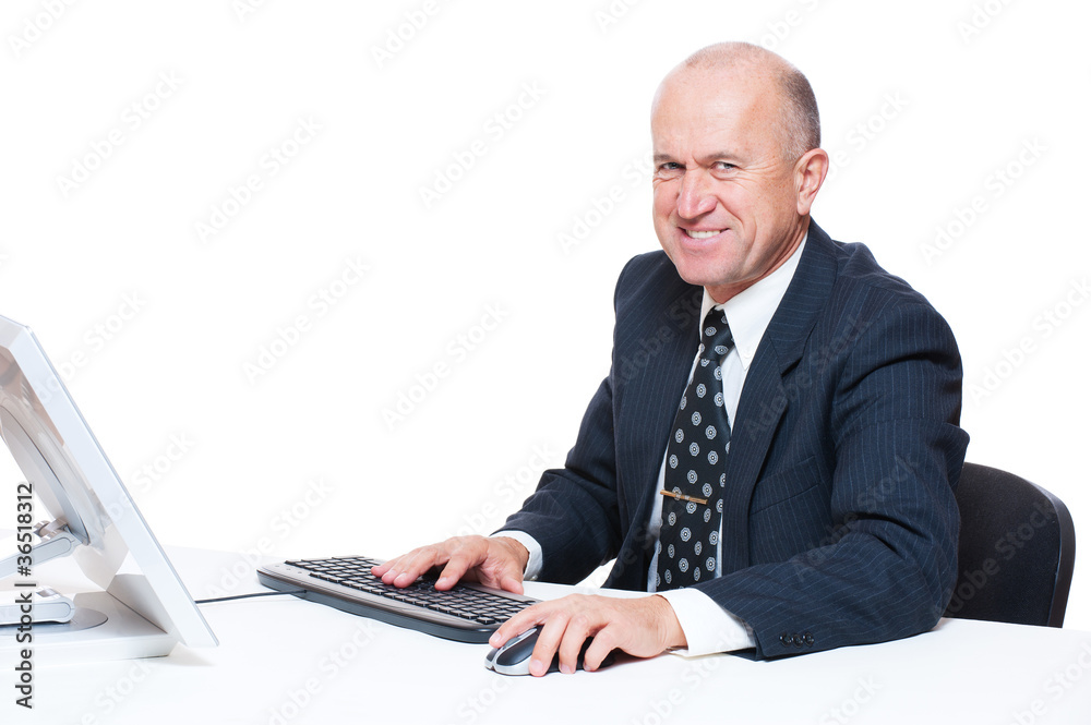 businessman sitting in workplace and smiling businessman sitting in workplace and smiling
