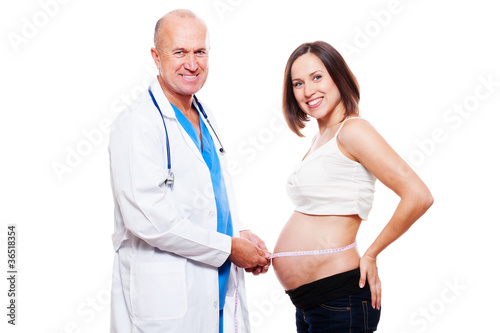 doctor measuring stomach at pregnant woman