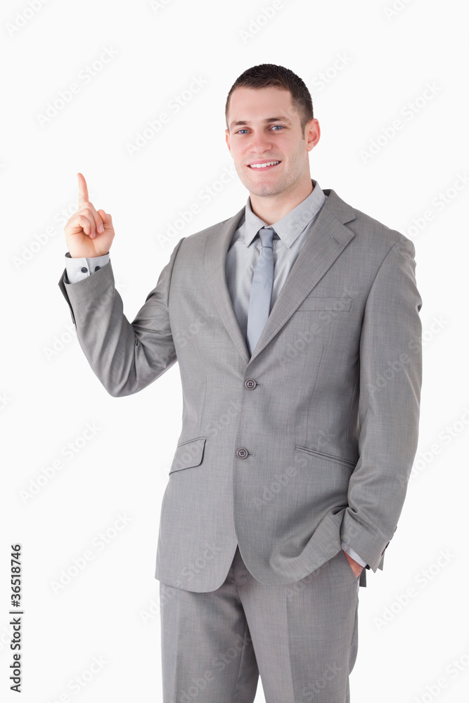 Portrait of a smiling young businessman pointing at something Portrait of a smiling young businessman pointing at something