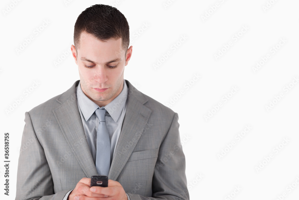 Businessman dialing on his cellphone Businessman dialing on his cellphone