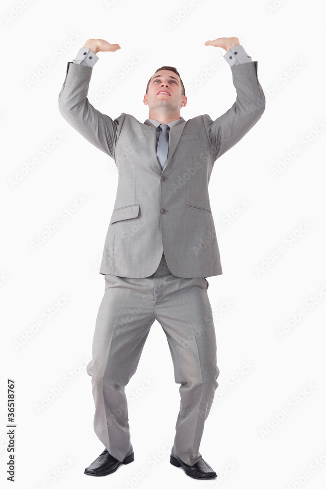 Portrait of a handsome businessman pushing the roof Portrait of a handsome businessman pushing the roof