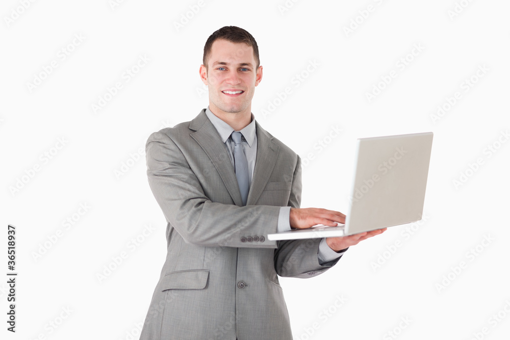 Businessman posing with a laptop Businessman posing with a laptop