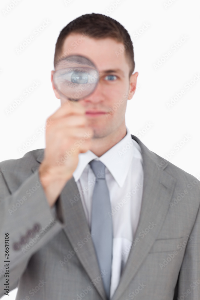 Portrait of a businessman looking through a magnifying glass Portrait of a businessman looking through a magnifying glass