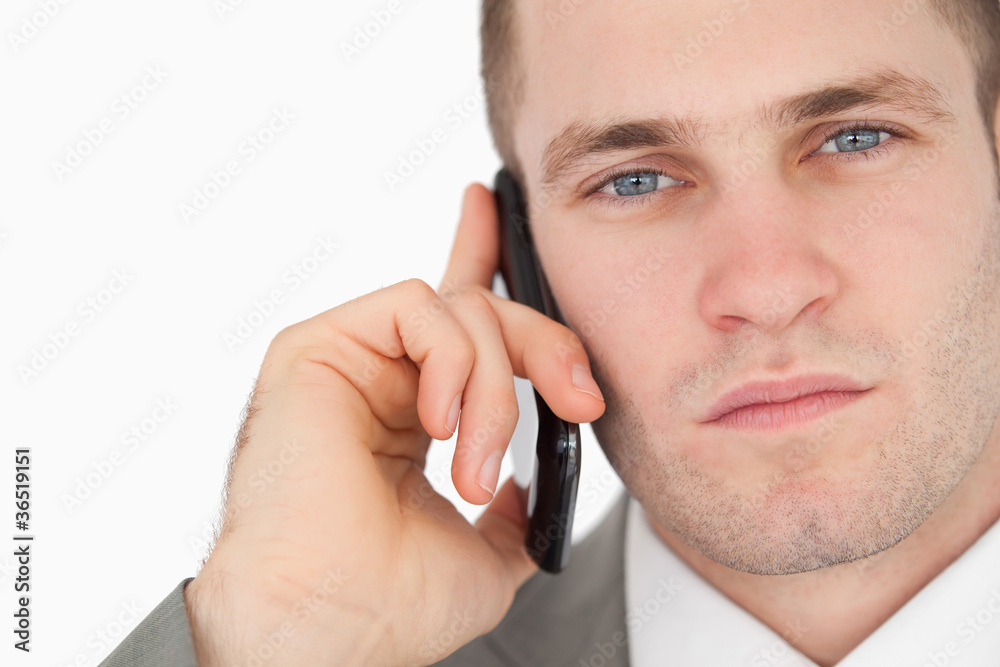 Close up of a focused businessman making a phone call Close up of a focused businessman making a phone call