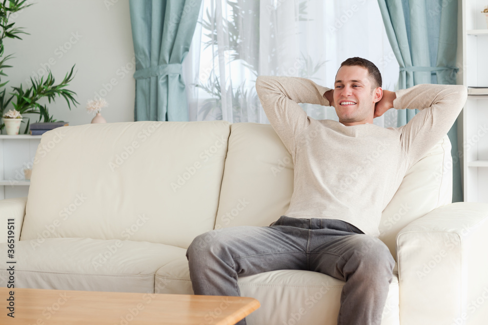 Happy man relaxing on a couch Happy man relaxing on a couch