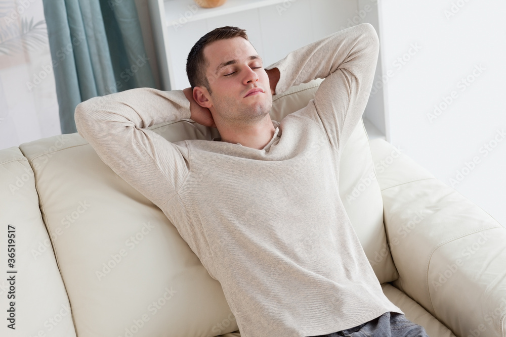 Man resting on a sofa Man resting on a sofa