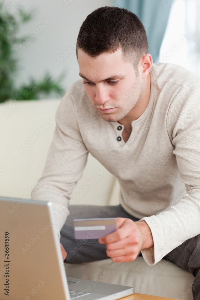 Portrait of a man using a notebook to book a flight