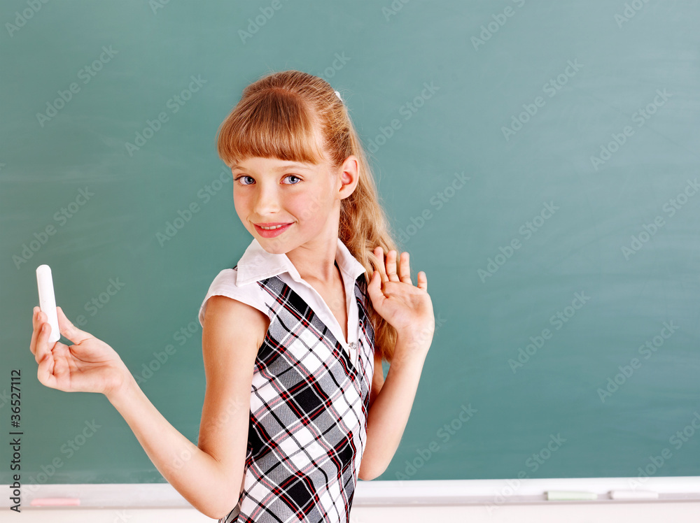 Schoolchild writing on blackboard. Schoolchild writing on blackboard.