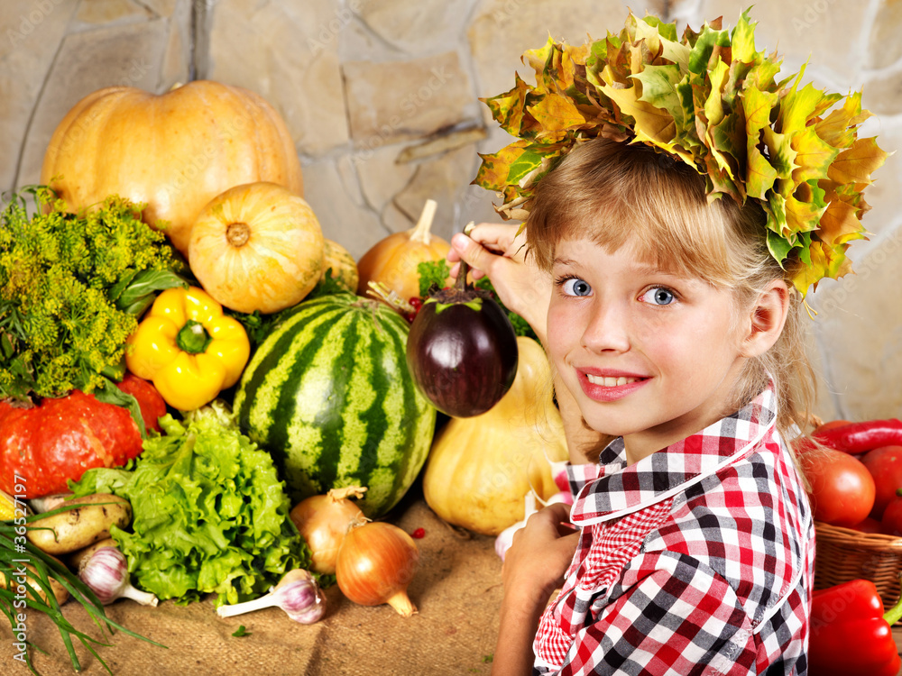Fototapeta premium Child with vegetable on kitchen.