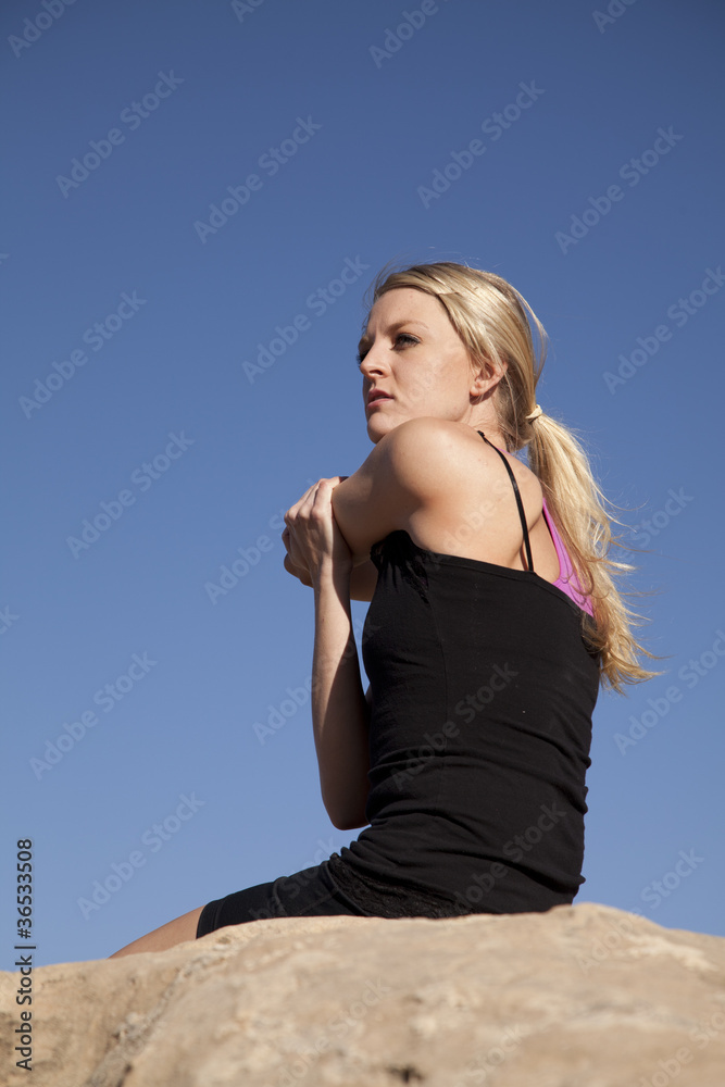woman sit rock stretch