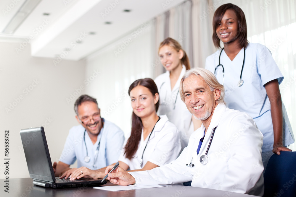Attractive female doctor working on her laptop Attractive female doctor working on her laptop