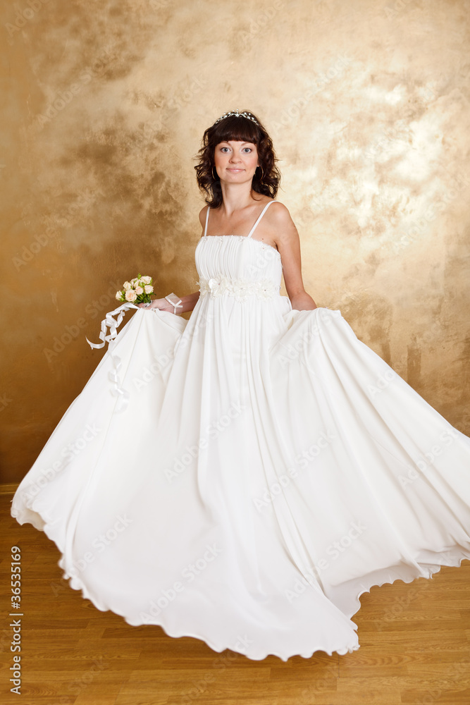 Beautiful dark haired woman in white bridal dress