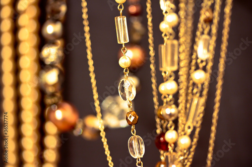 golden necklaces and gems, shallow dof on black