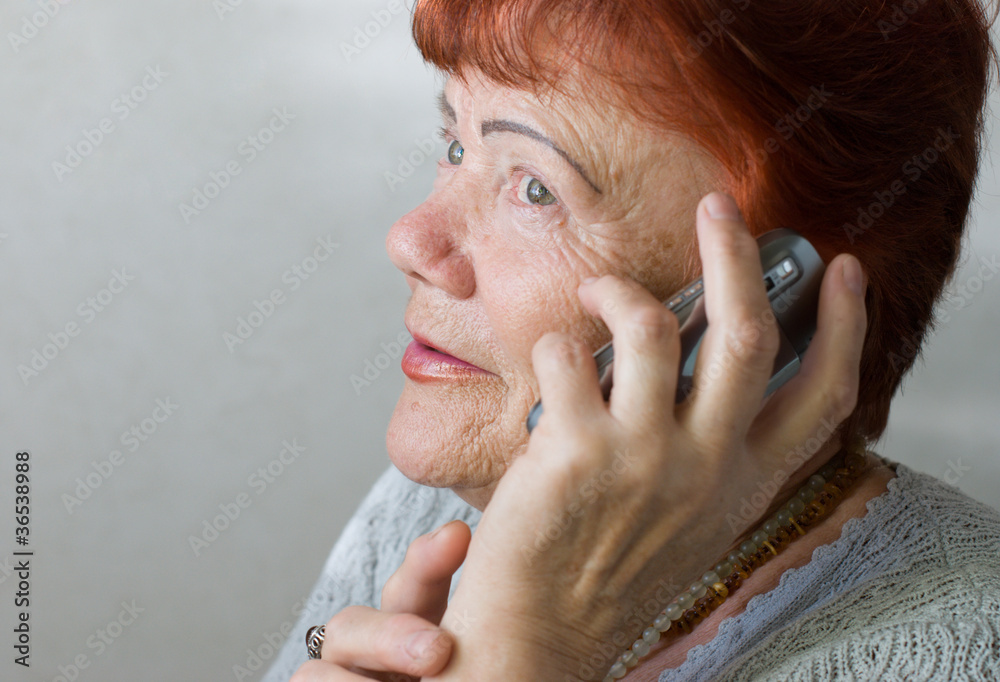 Seventy year old woman with cellphone Seventy year old woman with cellphone