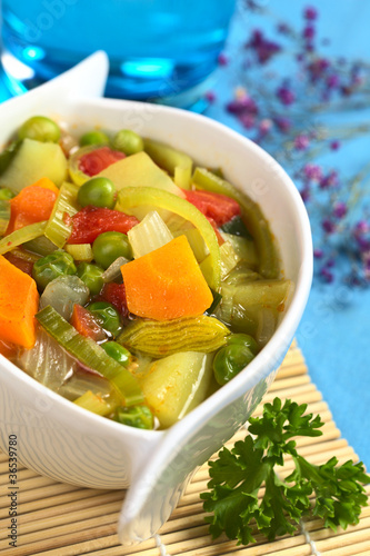 Vegetable soup made of carrot, leek, pea, potato, onion, tomato