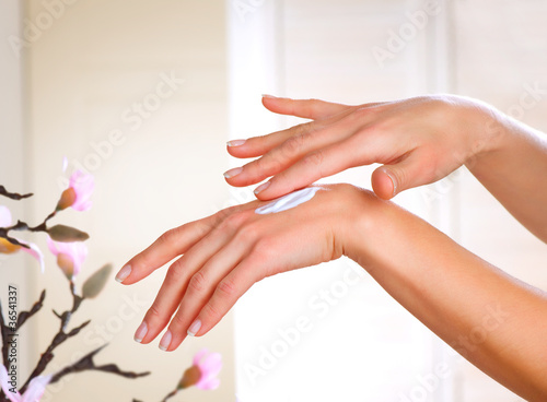 Female applying moisturizer to her Hands