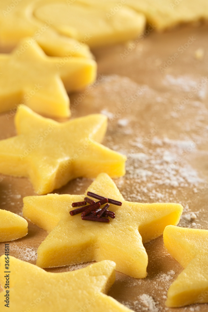 Unbaked star-shaped cookies with chocolate sprinkles Unbaked star-shaped cookies with chocolate sprinkles