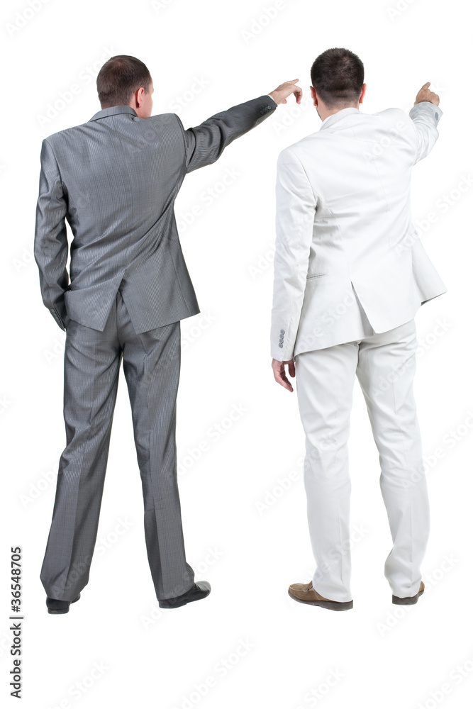 Back view of two businessman pointing at wall. rear view. Back view of two businessman pointing at wall. rear view.