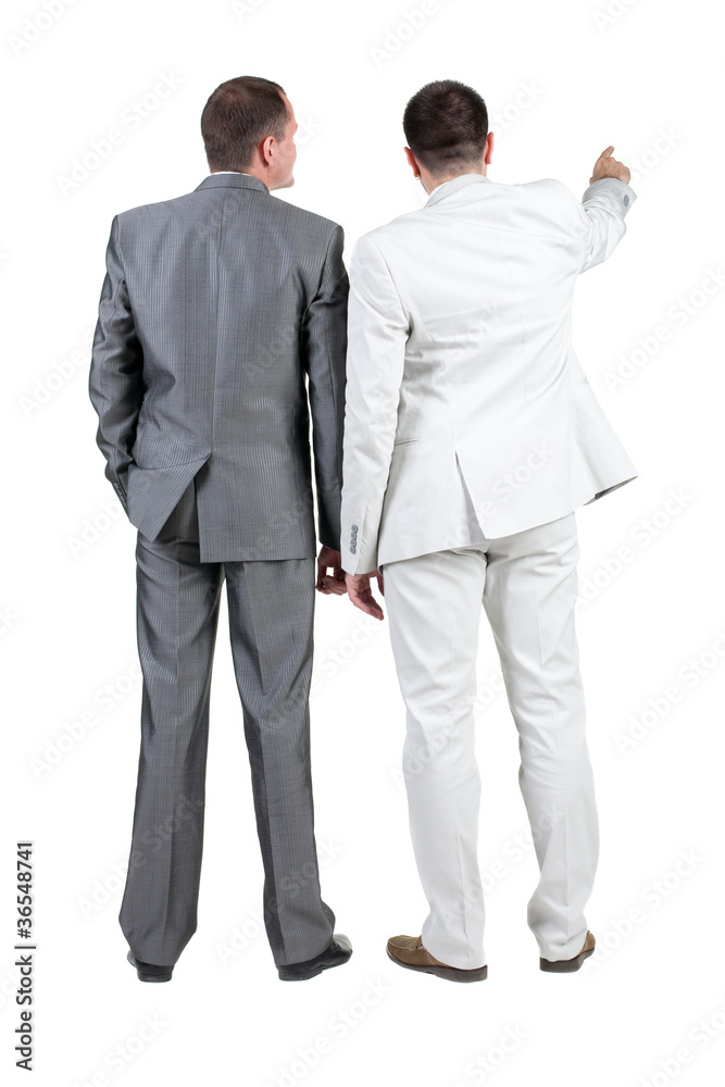 Back view of two businessman pointing at wall. rear view. Back view of two businessman pointing at wall. rear view.