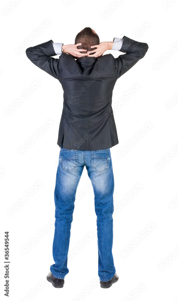 Back view of shocked and scared young business man. Holds hands Back view of shocked and scared young business man. Holds hands