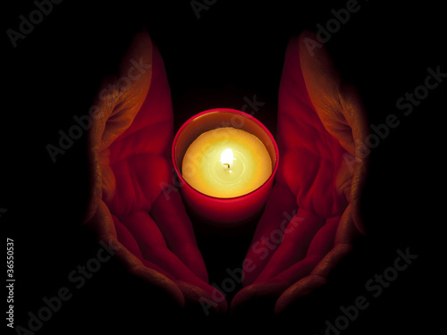 In memoriam - hands with votive candle photo