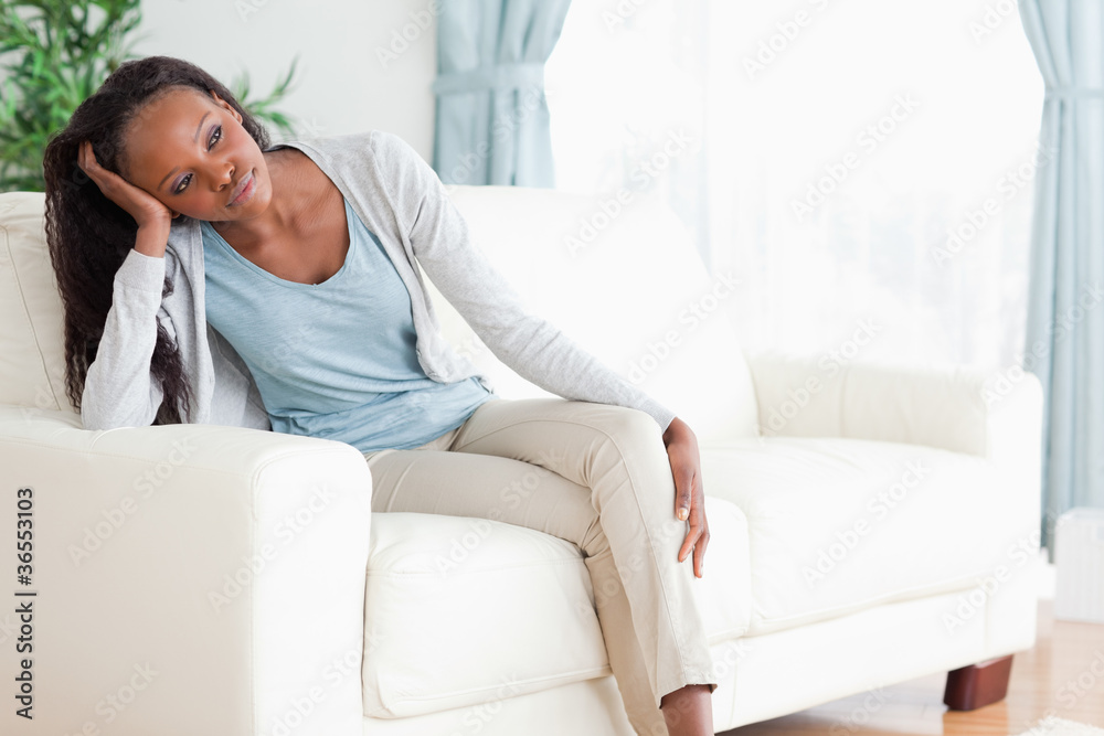 Woman on sofa in thoughts Woman on sofa in thoughts
