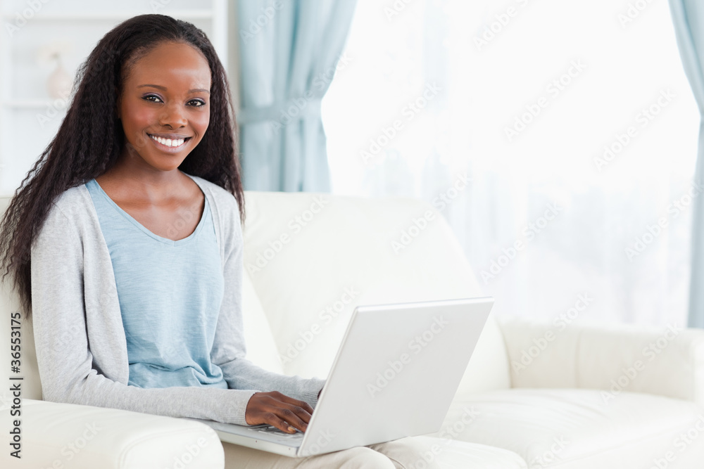 Woman typing on her notebook