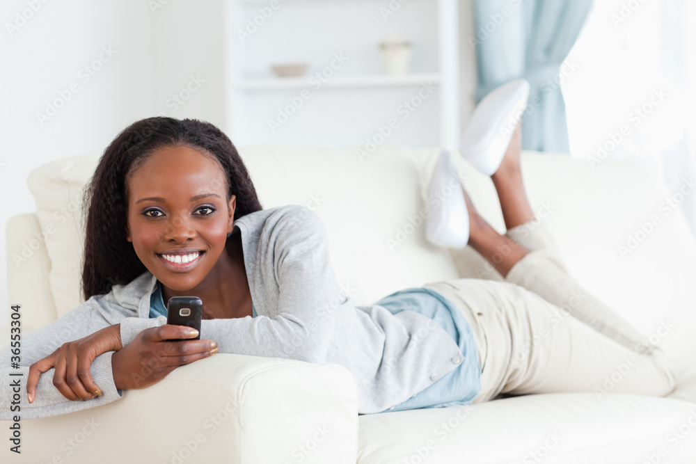 Woman texting on sofa Woman texting on sofa