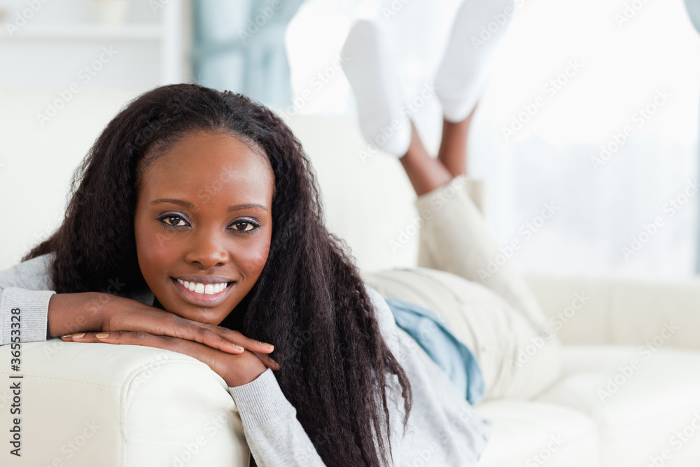 Smiling woman lying on couch Smiling woman lying on couch