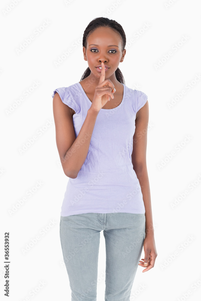 Close up of woman asking for silence on white background Close up of woman asking for silence on white background