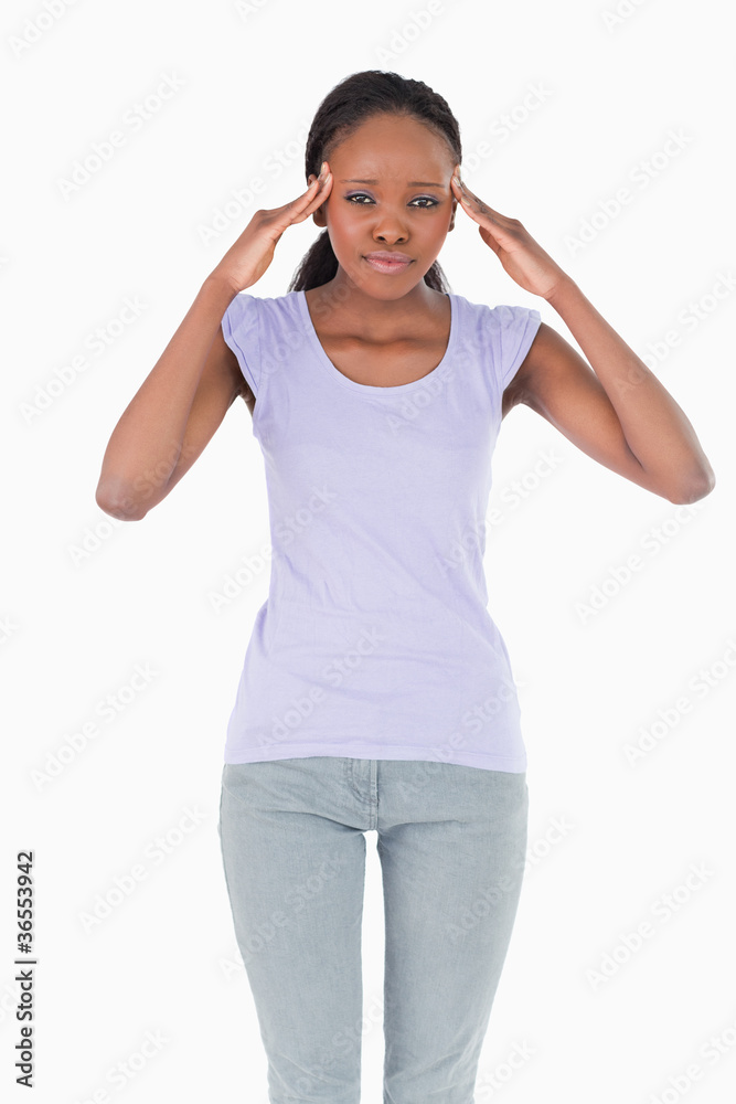 Close up of woman with hands at her temples on white background Close up of woman with hands at her temples on white background