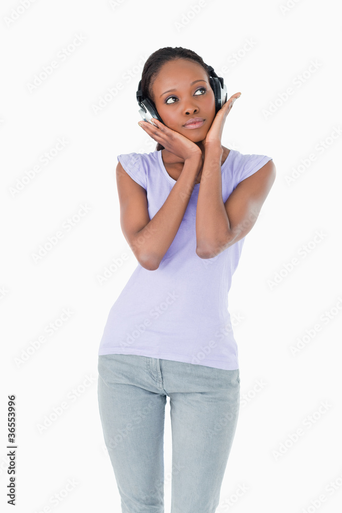 Close up of woman enjoying music with headphones on white backgr Close up of woman enjoying music with headphones on white backgr