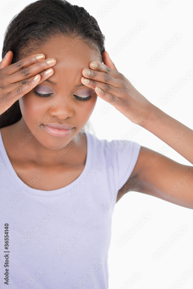 Close up of woman experiencing a headache on white background Close up of woman experiencing a headache on white background