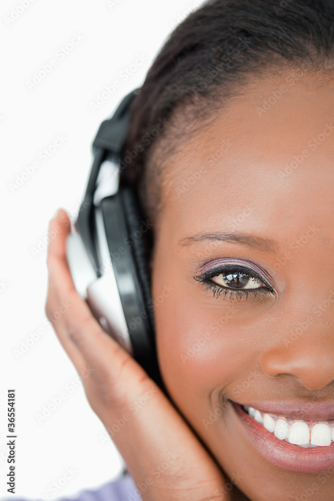 Close up of young woman with headphones on white background Close up of young woman with headphones on white background