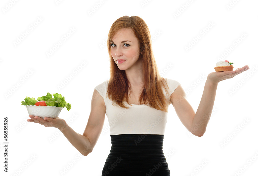 Young woman choice lettuce salad or cake. Isolated on white Young woman choice lettuce salad or cake. Isolated on white