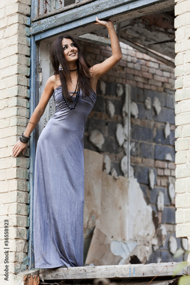 fashionable woman at the grunge window