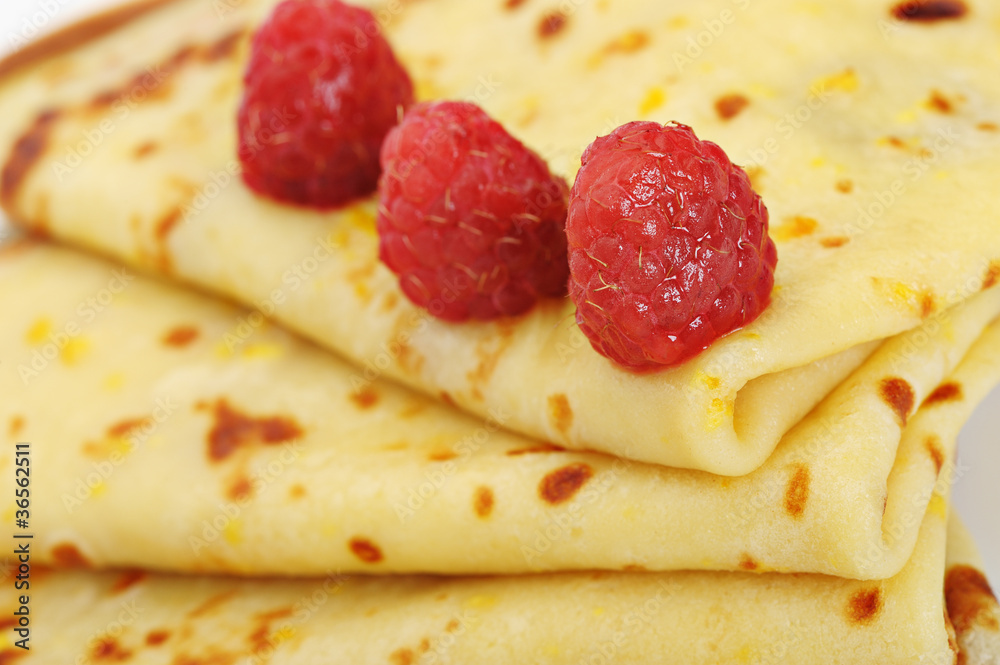 Crepe on a plate with a raspberry Crepe on a plate with a raspberry