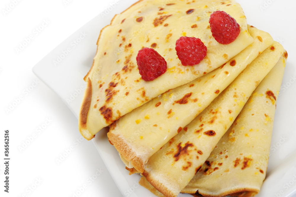 Crepe on a plate with a raspberry Crepe on a plate with a raspberry