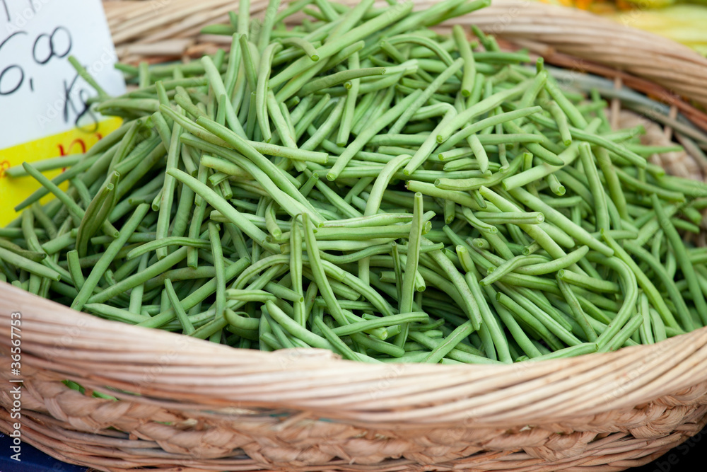 Green string beans in woven basket close-up Green string beans in woven basket close-up