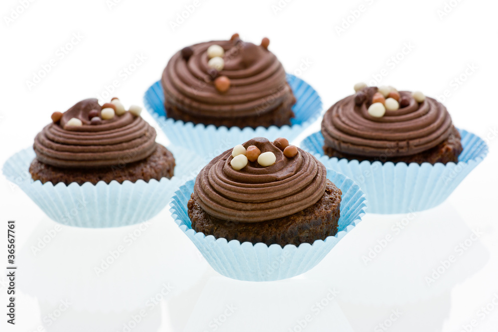 Chocolate cupcake with decorations on white. Chocolate cupcake with decorations on white.