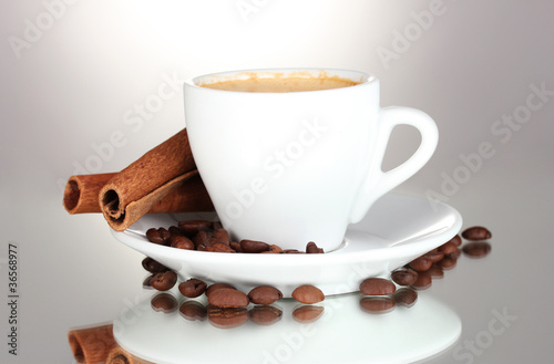 cup of coffee, cinnamon and coffee beans isolated on white