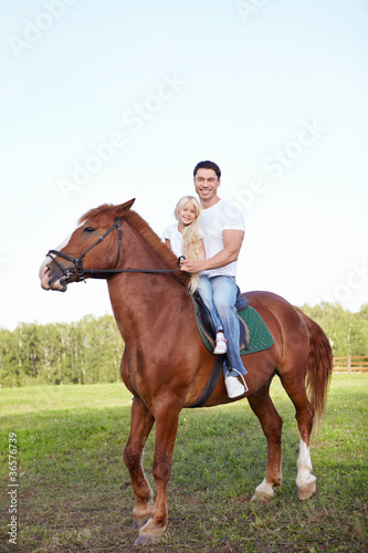 Little girl with her father on a horse © AboutLife