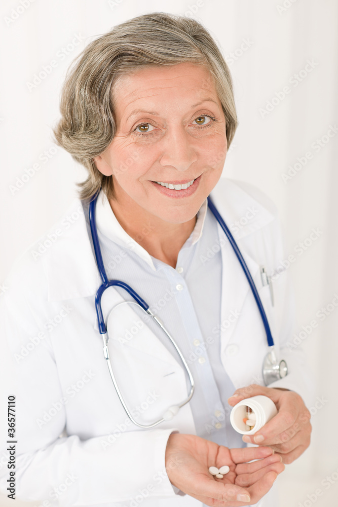Medical doctor senior female hold pills smiling Medical doctor senior female hold pills smiling