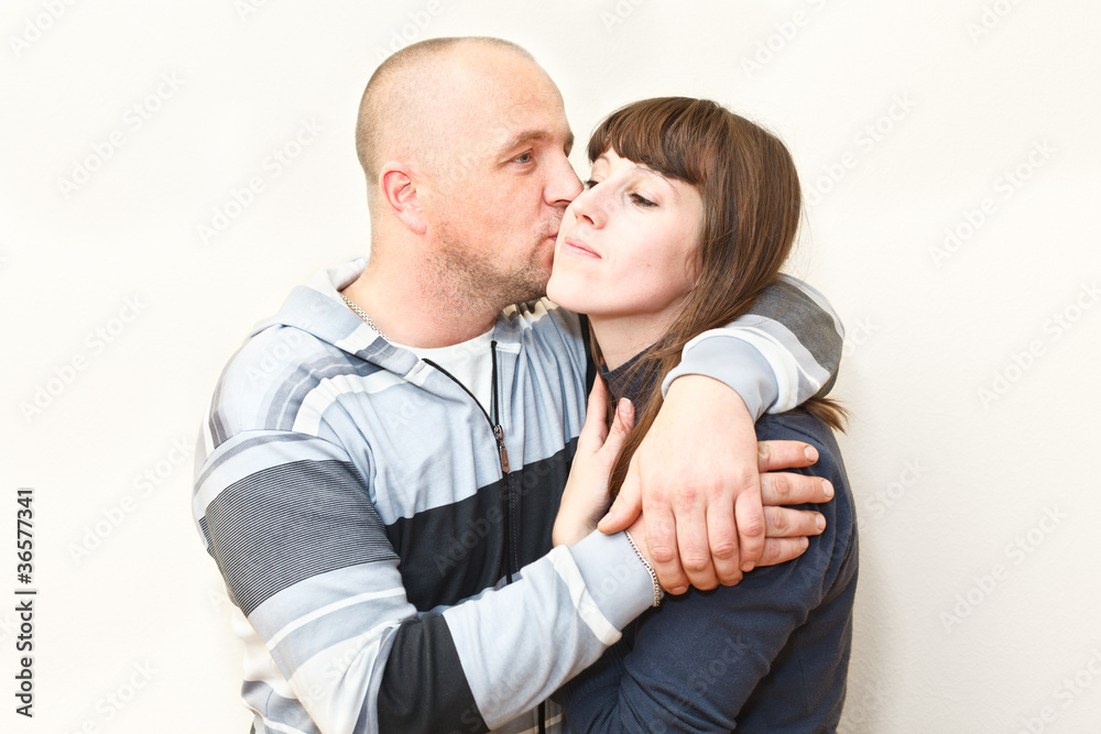 Loving couple kissing and embracing together Loving couple kissing and embracing together